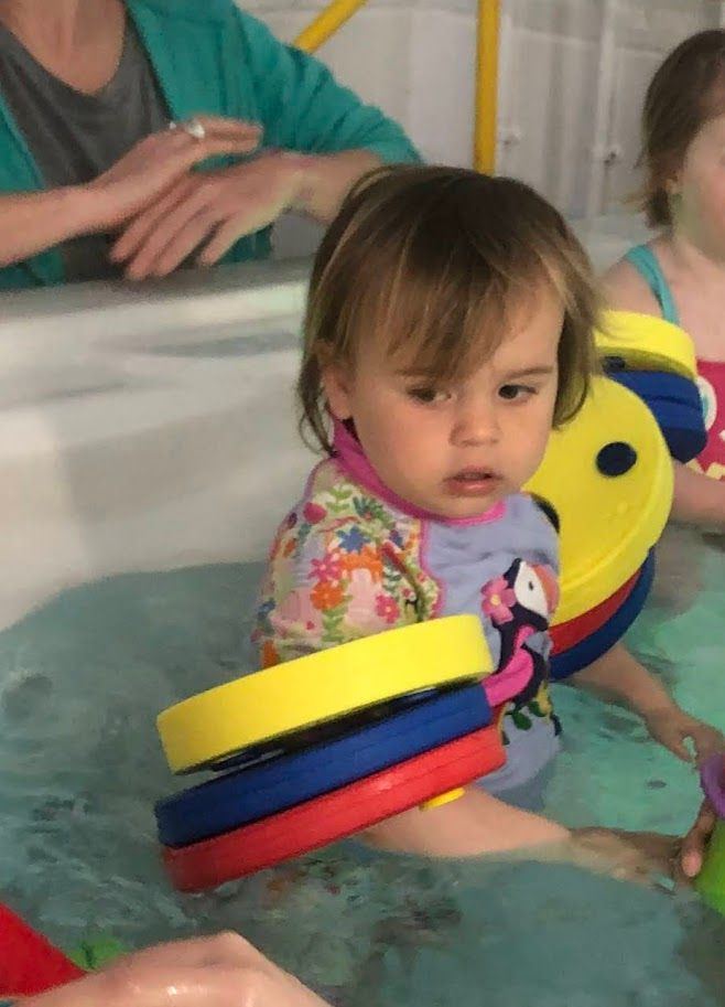A child playing with colourful props